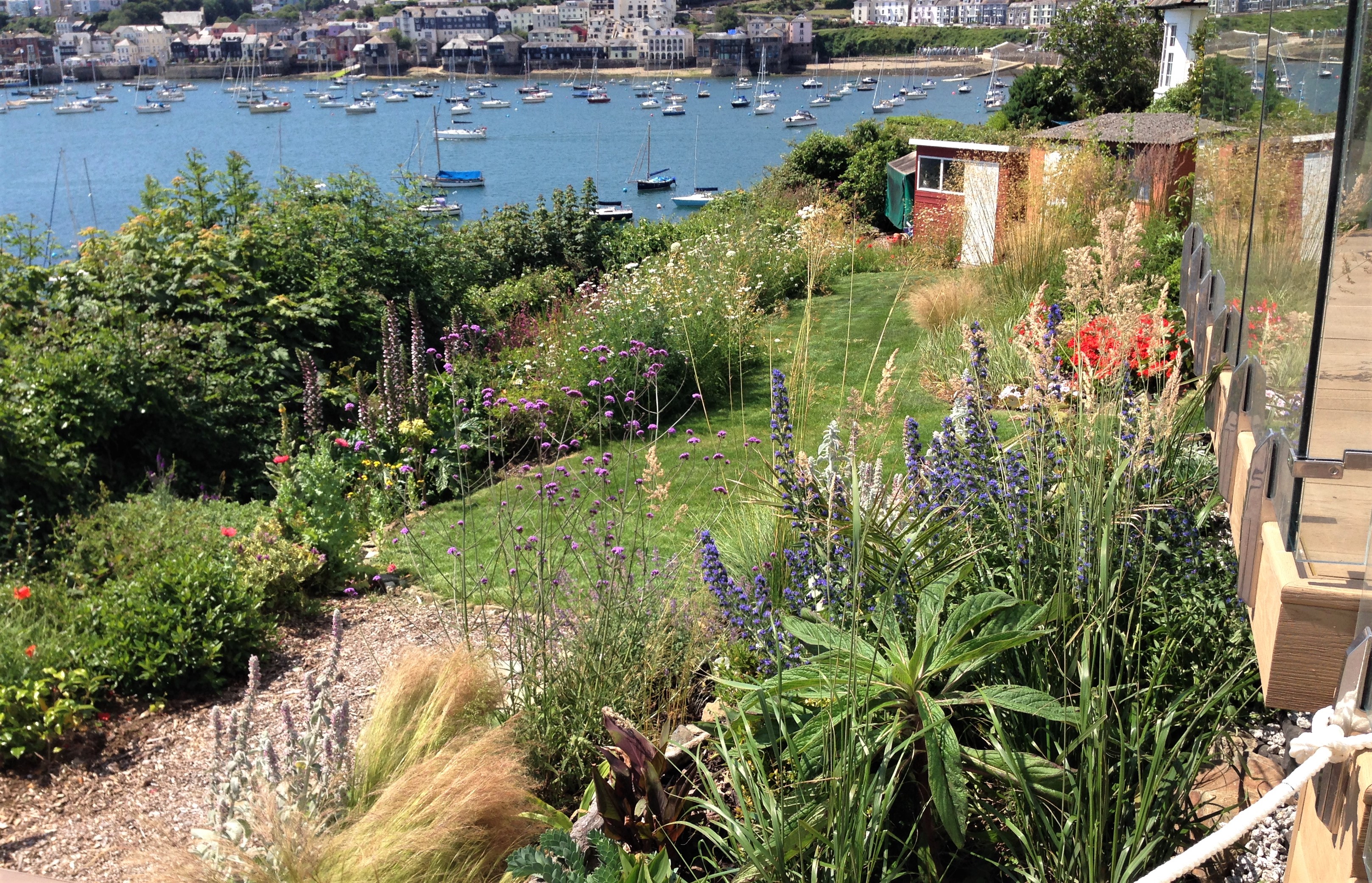 view of hot tub set within landscaped retaining walls enjoying views out to sea